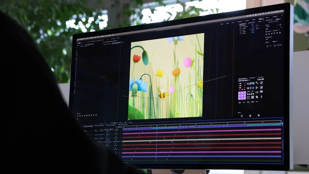 A motion designer at work in After Effects in the Morbegno studio